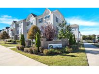 View of the Mallard Mill community entrance with landscaping and multi-story residential buildings at 1128 Newell Towns Ln, Charlotte, NC 28262