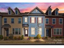 Charming townhome featuring a colorful facade, landscaped front yard, and a welcoming entrance at 11332 Westbranch Pkwy, Davidson, NC 28036
