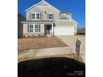 Charming two-story home featuring a two-car garage and neutral-colored siding with stone accents at 121 Goorawing Ln, Mooresville, NC 28115