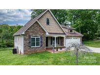 Charming home featuring a combination of stone and shingle siding with an attached two-car garage at 1263 Waterford Dr, Hickory, NC 28602