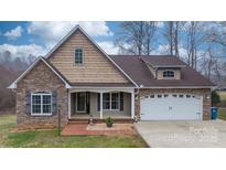 Inviting exterior of a two-story home with a combination of stone and shingle siding at 1263 Waterford Dr, Hickory, NC 28602