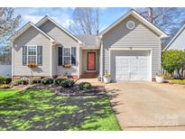 Charming home featuring well-maintained landscaping, a red front door, and a one car garage at 2318 Kestrel Dr, Rock Hill, SC 29732