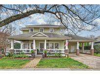 Charming two-story home with a covered porch, landscaped front yard, and inviting curb appeal at 426 Magnolia Ave, Charlotte, NC 28203