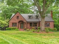 Charming brick home featuring a well-manicured lawn and mature trees at 600 S Central Ave, Belmont, NC 28012