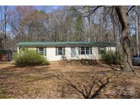 Cozy home featuring a well-kept lawn and charming front porch, ideal for relaxing and enjoying the outdoors at 7597 Webbs Rd, Denver, NC 28037