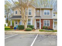 Inviting townhome exterior with manicured landscaping, brick accents, and convenient parking at 8364 Chaceview Ct, Charlotte, NC 28269