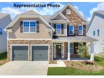 Charming two-story home featuring a two-car garage and a welcoming front porch at 121 Asmodean Ln, Troutman, NC 28166