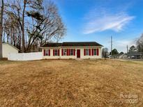 Inviting single-story home featuring red shutters and a well-maintained front lawn at 1313 Ridgewood Dr, Concord, NC 28027