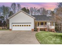 Charming single-story home featuring an attached two-car garage and well-maintained lawn at 195 Sandalwood Ln, China Grove, NC 28023
