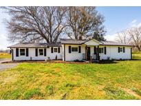 View of the well-kept lawn and landscaping in front of this inviting single-story home at 1993 Moss Farm Rd, Hickory, NC 28602