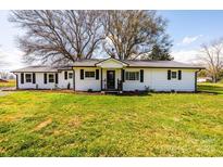 Charming single-story home featuring a well-manicured lawn and freshly painted exterior at 1993 Moss Farm Rd, Hickory, NC 28602