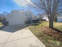 Charming two-story home featuring a well-maintained lawn, attached garage, and inviting curb appeal at 2115 Genesis Dr, Monroe, NC 28110