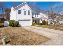 Charming two-story home with a well-maintained lawn, attached garage and a long driveway at 2627 Highland Park Dr, Charlotte, NC 28269