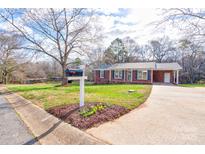 Charming brick home with blue shutters, well-maintained lawn, and inviting curb appeal at 301 Southglenn Dr, Shelby, NC 28152