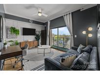 Inviting living room with plush seating, modern décor, and a sliding glass door to a balcony at 715 N Church St # 503, Charlotte, NC 28202