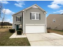 Charming two-story home featuring gray siding, a two-car garage, and a well-maintained front yard at 117 Hunter Park Dr, York, SC 29745