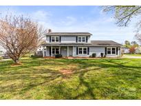 Charming two-story home features a well-maintained lawn, mature tree, and classic colonial architecture at 1448 Morrocroft Trl, Gastonia, NC 28054
