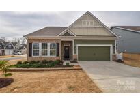 Charming single-Gathering home featuring a brick and siding facade, a two-car garage, and a well-manicured lawn at 1638 Sweetmoss Loop, Denver, NC 28037