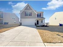 Charming two-story home with a two-car garage and a well-manicured front yard at 174 Hanging Rock Trl # 104, Statesville, NC 28625