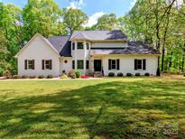 Charming two-story home with a well-manicured lawn and complemented by mature trees that offer shade and privacy at 207 Windsor Greene Dr, Monroe, NC 28110