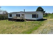 Charming home featuring a front porch, dark shutters, and a well maintained lawn at 24257 Austin Rd, Albemarle, NC 28001