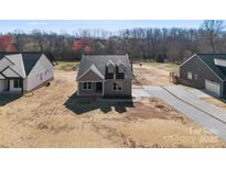 New construction home with gray siding, dormer windows, and a concrete driveway at 4029 Miller Rd, Salisbury, NC 28147