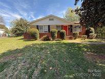 Charming single-story brick home with a well-maintained lawn and bright red front door at 4228 Brookway Dr, Charlotte, NC 28208