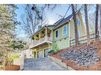 Charming two-story home with a welcoming balcony and well-maintained landscaping at 6008 Lanai Ln, Tega Cay, SC 29708