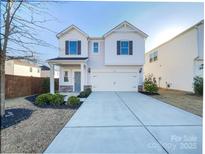 Charming two-story home with a well-maintained lawn and a classic architectural design at 7120 Saltpeter St, Charlotte, NC 28215