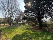 Expansive backyard with mature trees, offering a serene and private outdoor space for relaxation and recreation at 8402 Albury Walk Ln, Charlotte, NC 28277