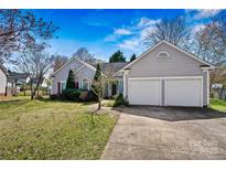 Charming single-story home featuring an attached two-car garage and well-manicured front lawn at 8402 Albury Walk Ln, Charlotte, NC 28277