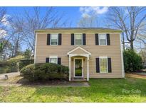 Traditional two-story home with a well-manicured lawn and classic architectural details at 8501 Golf Ridge Dr, Charlotte, NC 28277