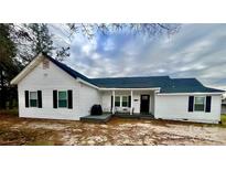Charming single-story home with white siding, black shutters, covered front porch and well-kept lawn at 102 Guffey Rd, Cherryville, NC 28021
