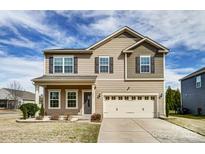 Charming two-story home showcasing a neutral color palette, well-maintained landscaping, and a two-car garage at 11203 Chapeclane Rd, Charlotte, NC 28278