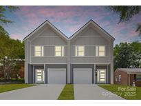 Modern townhomes with gray siding, individual driveways, and stylish entry doors create an inviting curb appeal at 1322 Condon St, Charlotte, NC 28216