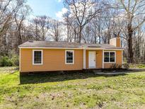 Charming single-story home with an inviting front yard and a classic design, creating a warm and welcoming curb appeal at 1327 Santee St, Charlotte, NC 28208