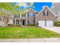 Charming brick two-story home with a landscaped front yard and a two-car garage at 13514 Porter Creek Rd, Charlotte, NC 28262