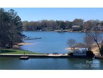 Scenic lake view with a gazebo and boardwalk, offering a serene waterfront setting with lush landscaping and peaceful ambiance at 18840 Nautical Dr # 57, Cornelius, NC 28031