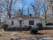 Quaint one-story home featuring a covered front porch and mature landscaping at 2039 Garland Ave, Gastonia, NC 28052