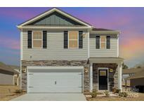 Attractive two-story home with stone accents, an attached garage, and a well-maintained lawn at 3309 Colorado Blue Ct, Gastonia, NC 28056