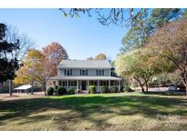 Charming two-story home with a welcoming front porch and well-maintained landscaping at 3424 Red Fox Trl, Matthews, NC 28104