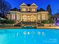 Stunning backyard featuring a luxurious pool, spa, and elegant outdoor entertaining space at 4510 Old Course Dr, Charlotte, NC 28277