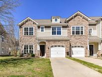 Townhouse boasts a stone front, attached garage and well-maintained landscaping at 4634 Craigmoss Ln, Charlotte, NC 28278