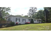 Charming single-story home with gray siding, black shutters, and a well-manicured lawn at 4790 Polk Ford Rd, Stanfield, NC 28163