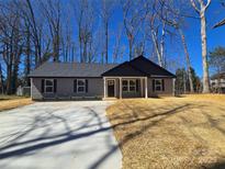 Charming single-story home with a well-manicured lawn and a concrete driveway at 636 Bee Tree Rd, Salisbury, NC 28146