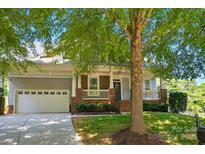 Charming home featuring a two-car garage, well-manicured lawn, and inviting front porch at 8008 Battersea Ct, Waxhaw, NC 28173