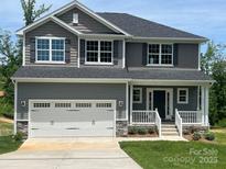 Charming two-story home featuring a spacious two-car garage, classic siding, and a welcoming front porch at 117 High Rock Ct # 9, Statesville, NC 28677