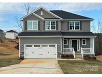 Two-story home featuring a gray exterior, white garage door, and a welcoming front porch at 117 High Rock Ct # 9, Statesville, NC 28677