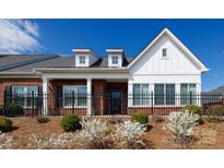 Charming brick and white facade with a black fence and manicured landscaping at 126 Adelaide Way, Rock Hill, SC 29732