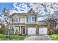 Two story home with a two car garage, stone accents and manicured lawn at 12889 Clydesdale Dr # 59, Midland, NC 28107